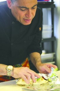 Serkan Erginkara cooks up a pre-ordered lunch. He also takes orders on the fly, over the phone and via Facebook. Photo by Aubrey Ann Parker