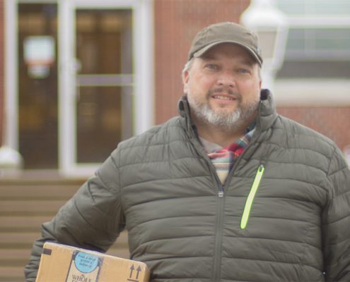 Josh Bedell is a mail carrier for the United States Postal Office. For 11 years, he worked as a substitute carrier all over the greater Northern Michigan region, including his hometown of Frankfort, pictured here. For the past two years, however, he has had his own route in Traverse City. Photo by Aubrey Ann Parker.